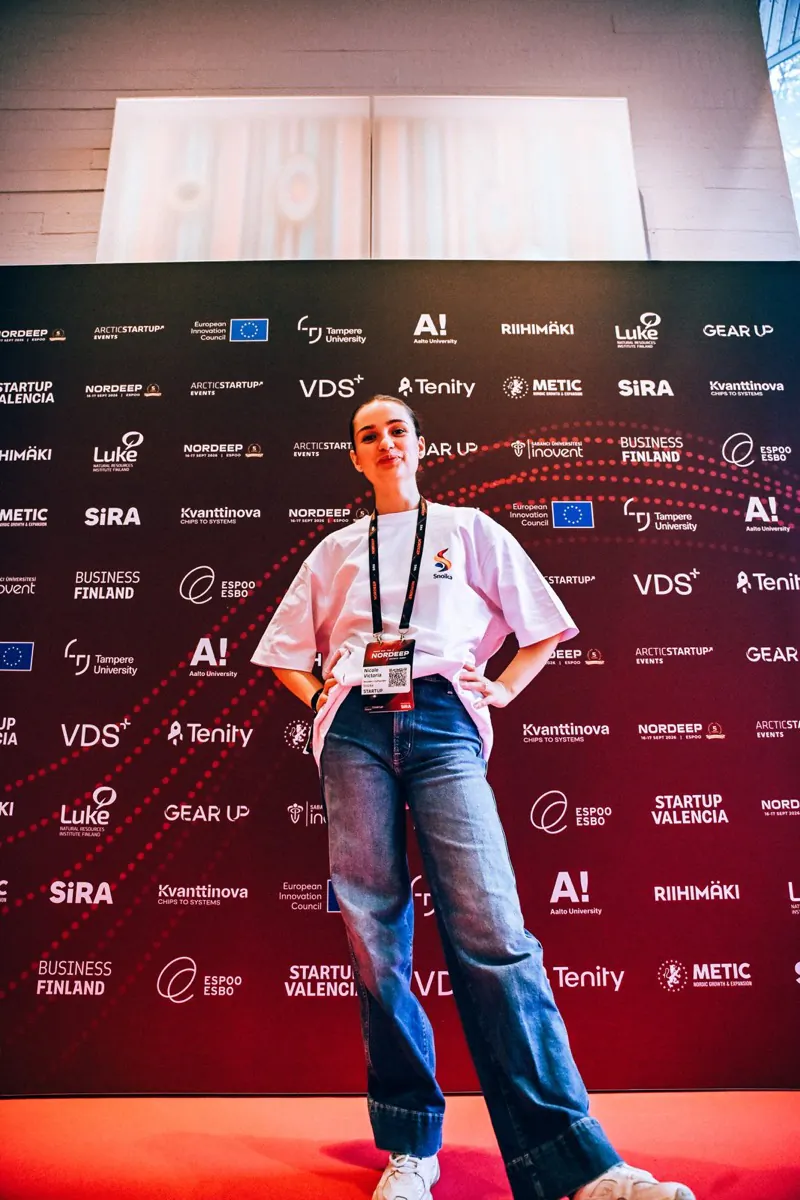 A Snoika team member in front of the NORDEEP partner wall