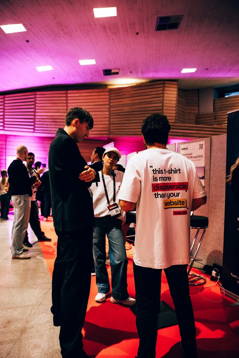 Visitors talking with the Snoika team at the stand