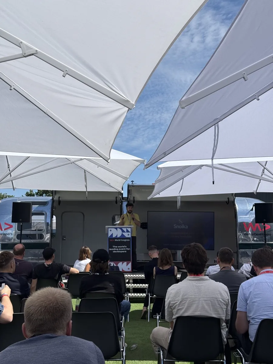 A talk on an outdoor stage with Snoika on the screen
