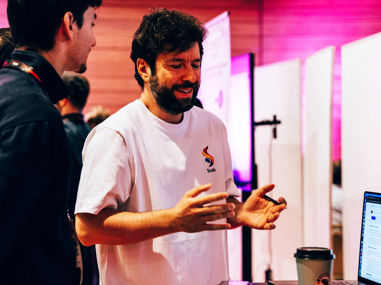 A Snoika team member walks a founder through an AI visibility check at the Snoika table at NORDEEP 2026
